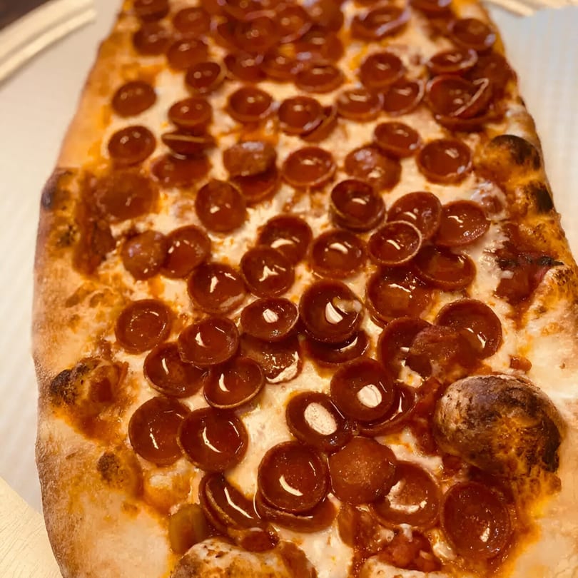 Close-up of a rectangular pepperoni pizza from Biaggio Pizzeria, with crispy crust and melted cheese.
